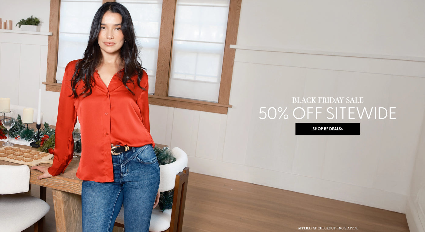 Woman in red shirt and blue jeans standing in a dining room with Black Friday sale text overlay.
