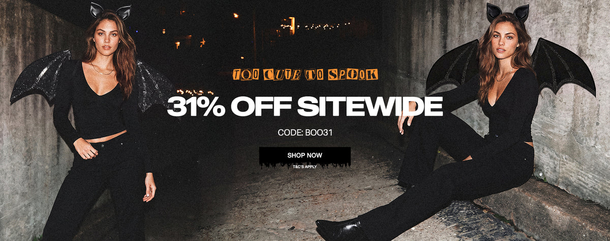 A promotional banner featuring two models wearing a black catgirl costume with bat wings and cat ears in a dark, moody setting. The center of the image features a large sale text overlay reading '31% OFF SITEWIDE' with a code and a 'SHOP NOW' button.