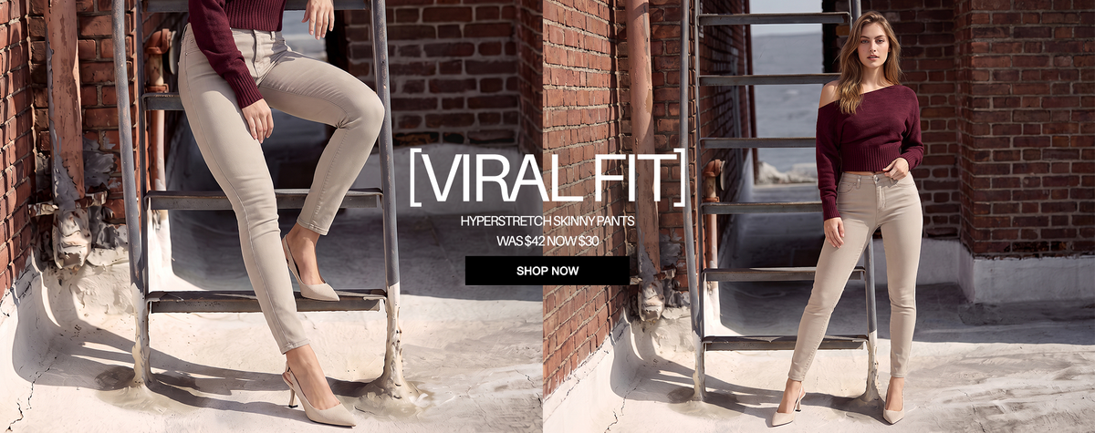 A split-screen promotional image showing a model wearing beige mid-rise skinny jeans with a burgundy long-sleeve top, posing in front of a brick wall and metal ladder. Large text reads '[VIRAL FIT] HYPERSTRETCH SKINNY PANTS'