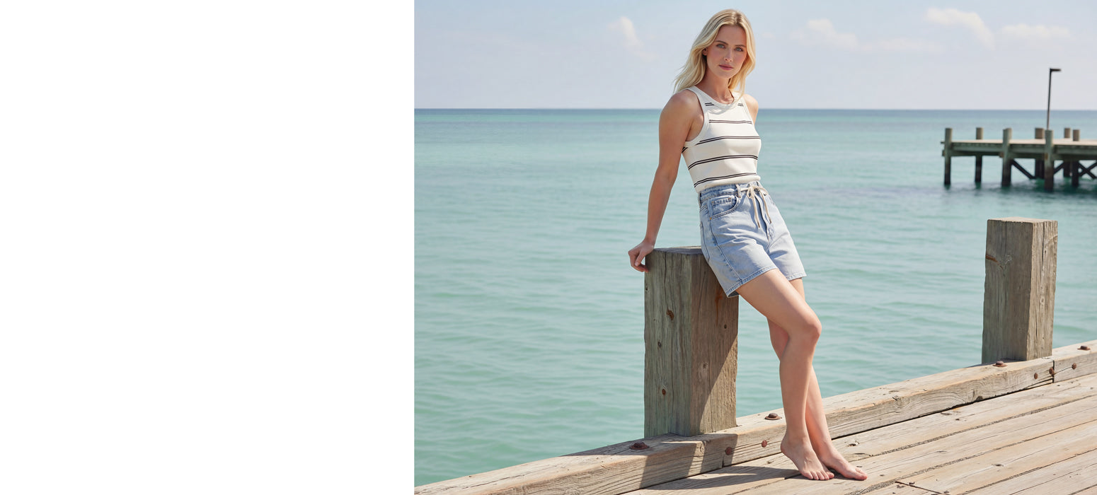 Woman sitting on a wooden dock by the water